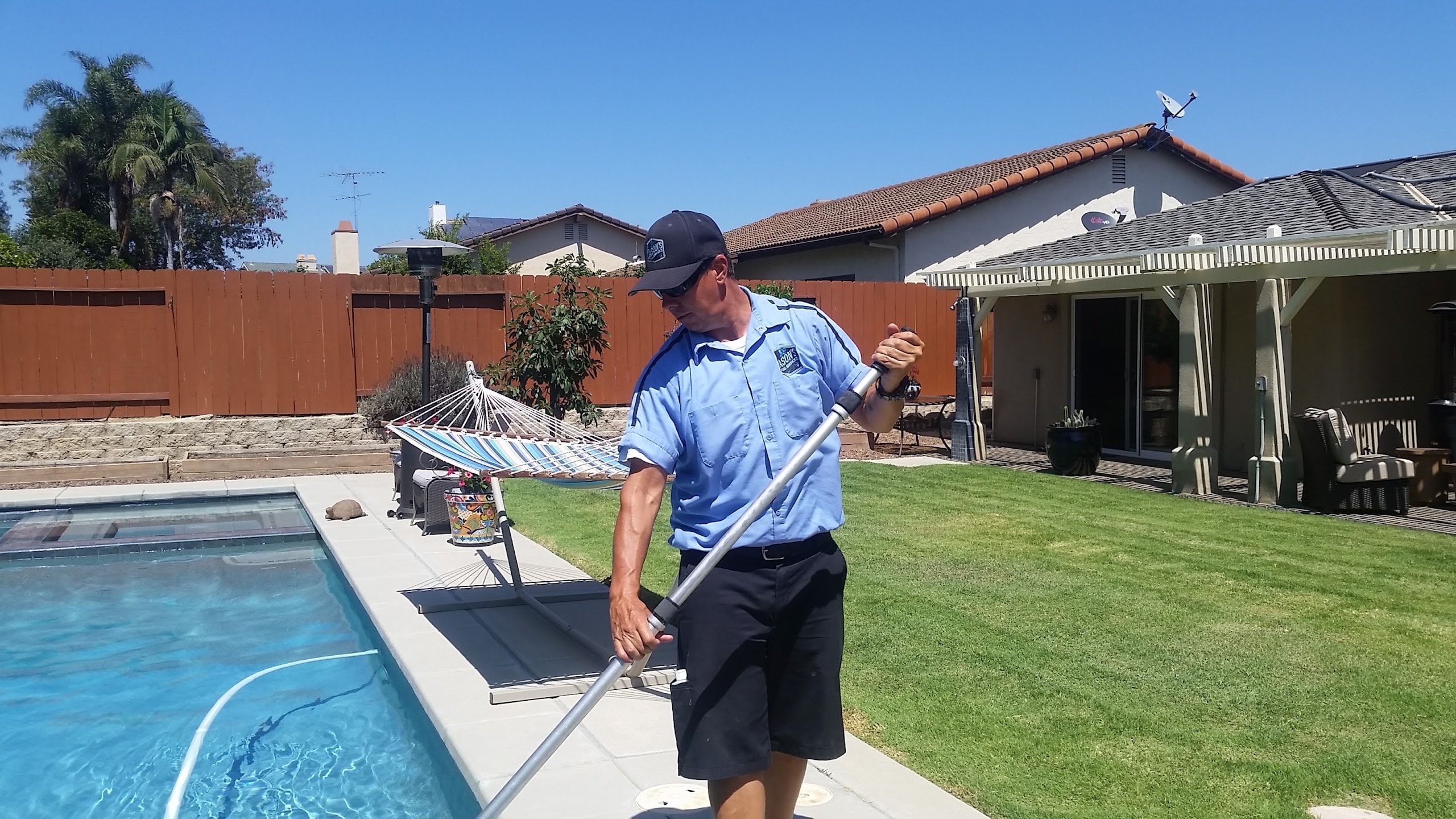 Pool technician performing weekly maintenance
